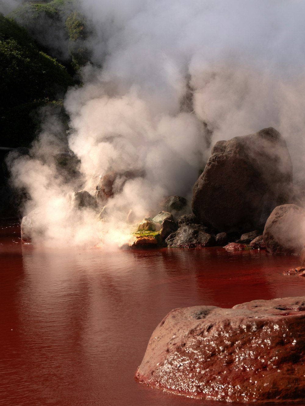Steaming red hot spring water at the hells of Beppu