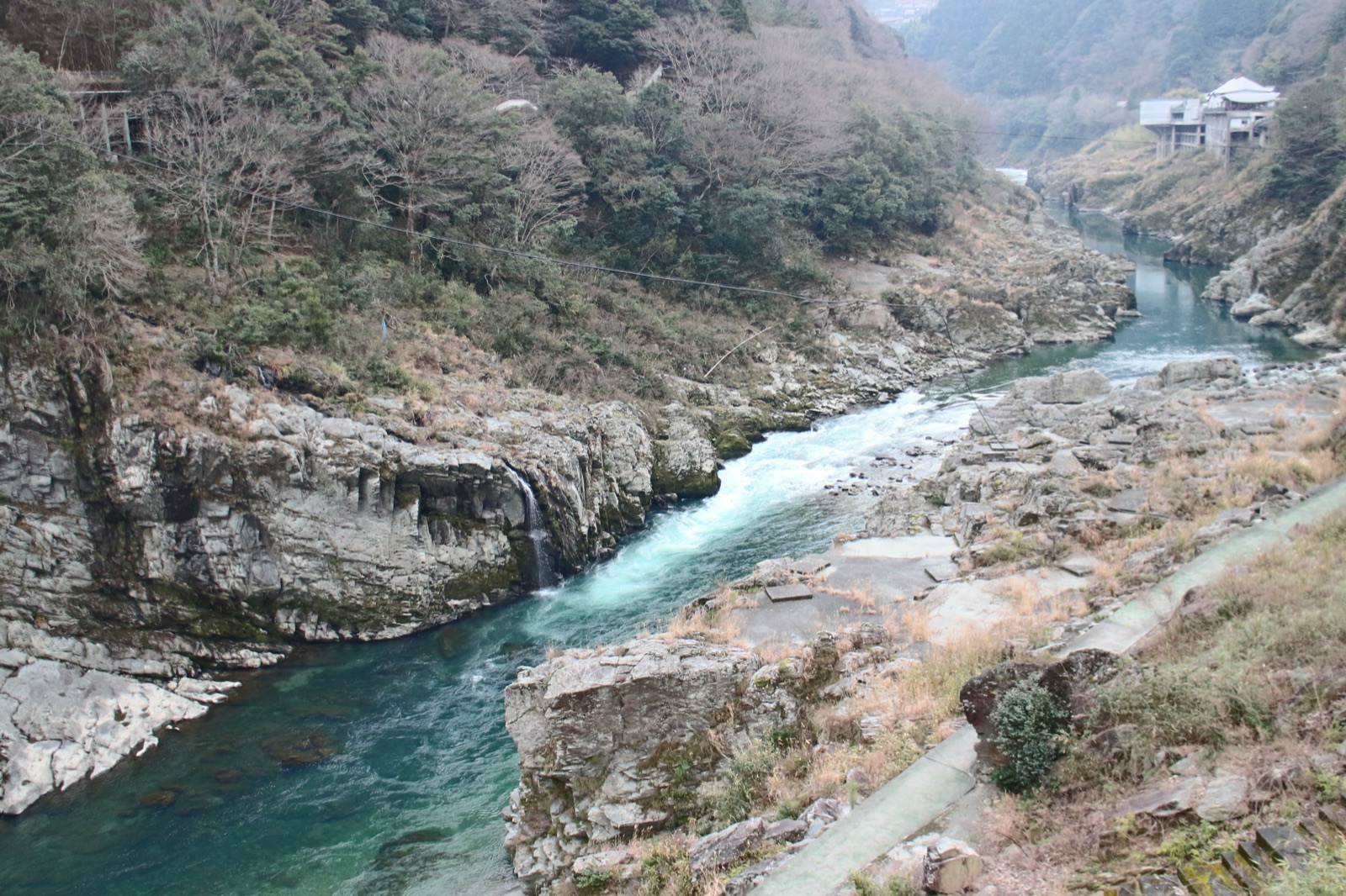 The emerald Yoshino River cutting through the rock walls of the Oboke gorge